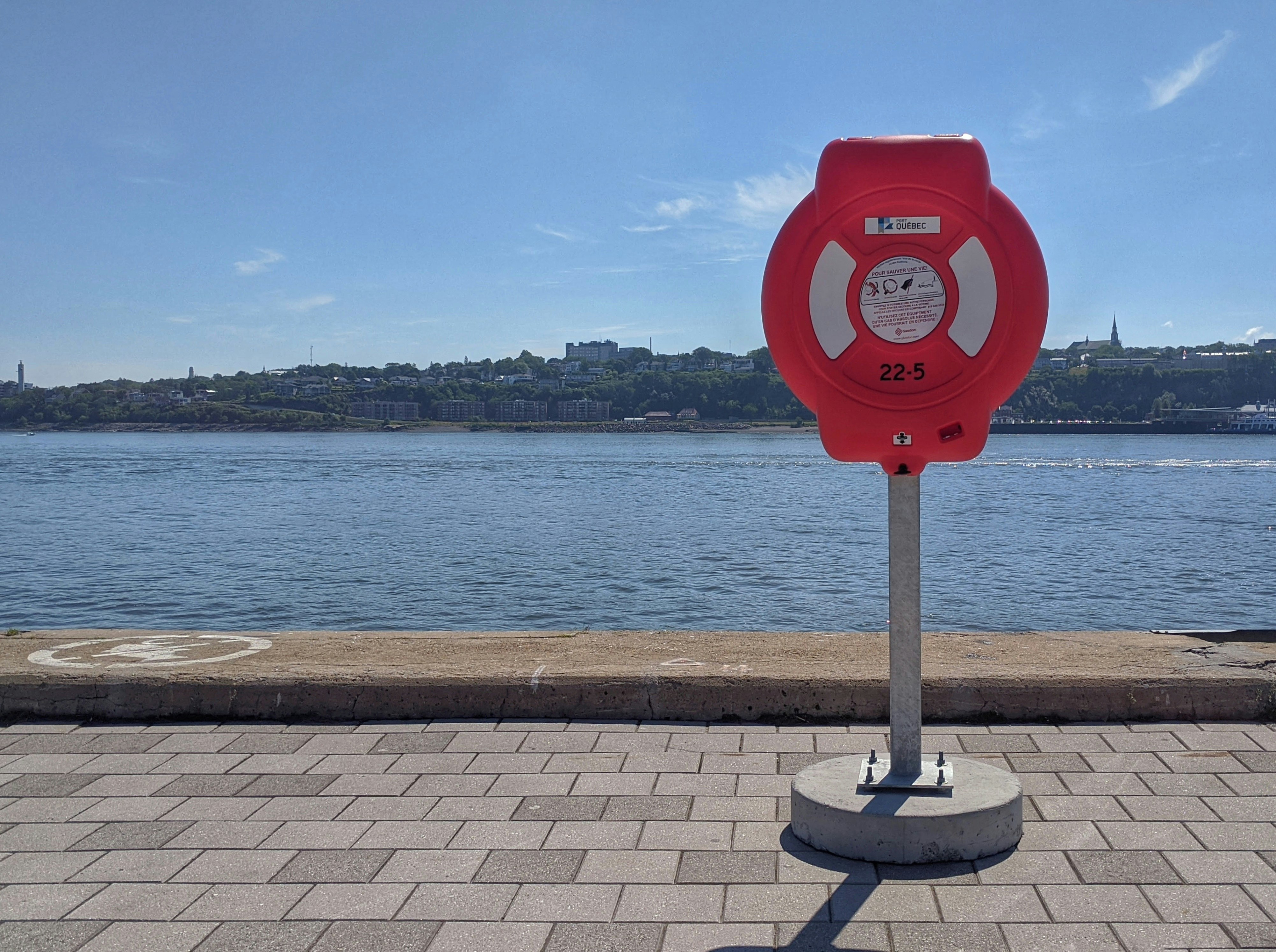 red and black telephone booth near body of water during daytime